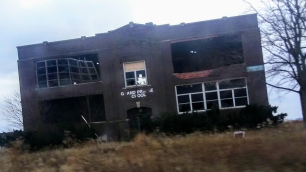 An abandoned school in the country Picture is a bit blurry and had to be edited to see better since it was taken in a moving car