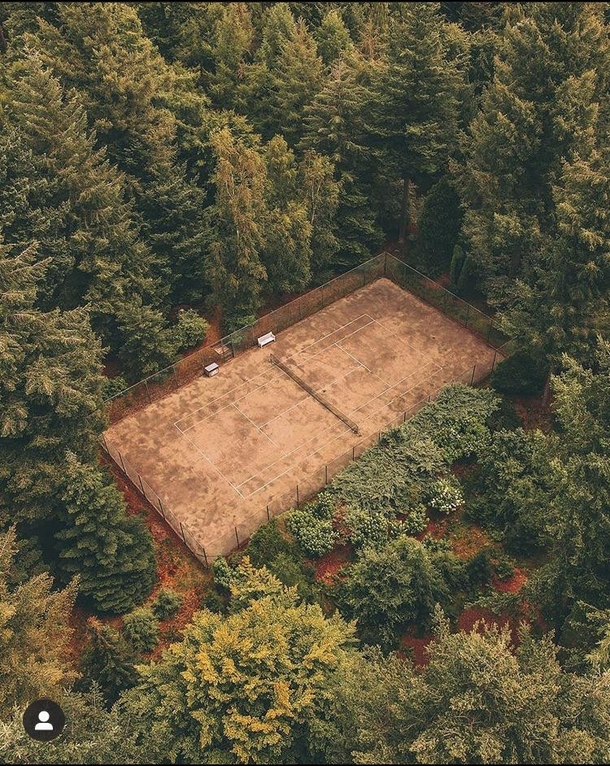 An abandoned tennis court in the woods credits httpsinstagramcomdrone_nijmegensigshidtcdbmy