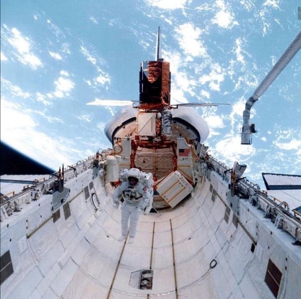 An astronaut floats in space shuttle challengers payload Bay on mission STS--C after a successful repair of solar max satellite