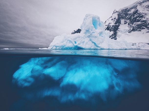 An iceberg from above and below From the Antarctica Peninsula  by danielbenjaminphoto