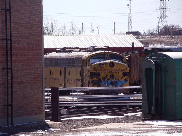 An old diesel train from the s sitting in Cheyenne tucked away missing its wheels