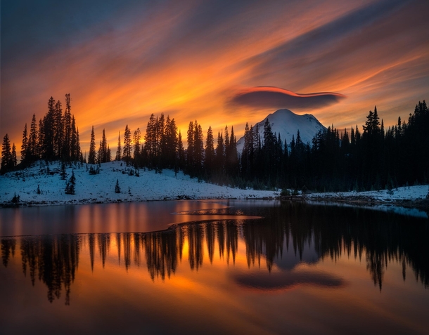 An underlit swooping lenticular cloud perfectly outlines Mt Rainier at Tipsoo Lake WAUSA