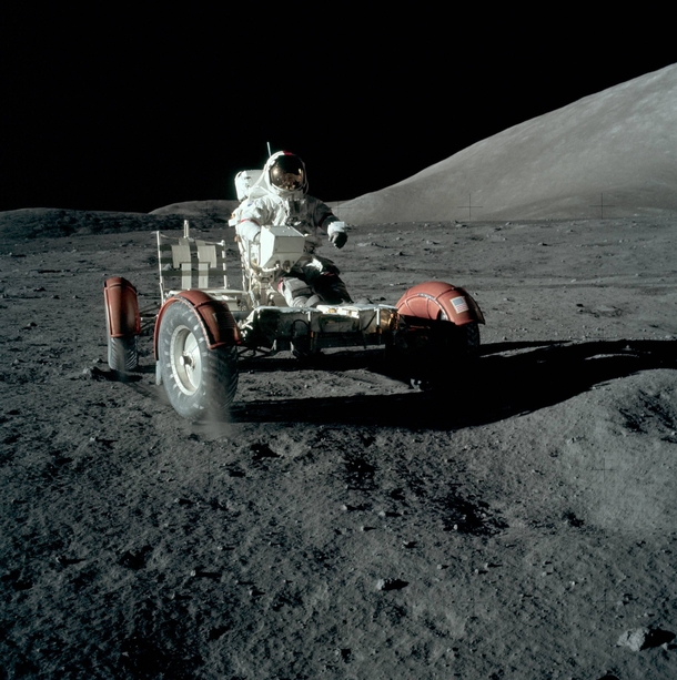 Apollo  astronaut Gene Cernan drives on the surface of the moon during the LRV initial test drive Note the dust being thrown up by the right-front wheel even at very low speed 
