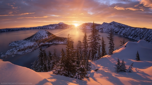Arclight - A golden winter sunrise at Crater Lake Oregon by Alex Noriega 