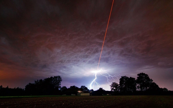 As ESO was testing the Wendelstein laser guide star unit Algu south Germany by shooting a powerful laser beam into the atmosphere one of the regions intense summer thunderstorms was approaching Credit ESOM Kornmesser