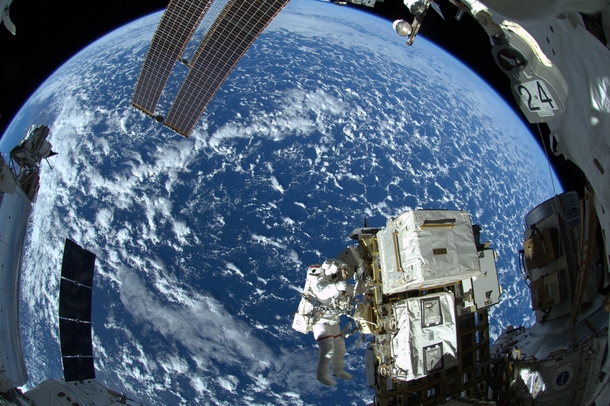Astronaut Reid Wiseman above our Blue Marble on the first spacewalk of Expedition  working in the vacuum of space for  hours and  minutes  NASAESAAlexander Gerst