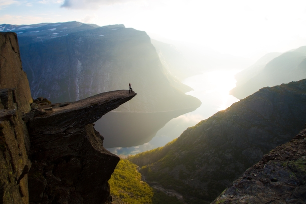 At the edge of Trolltunga  meters above Lake Ringedalsvatnet Norway  Photo by Christopher Baldry