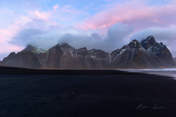 Beautiful pink hues against rising mountains Vestrahorn Iceland   x 