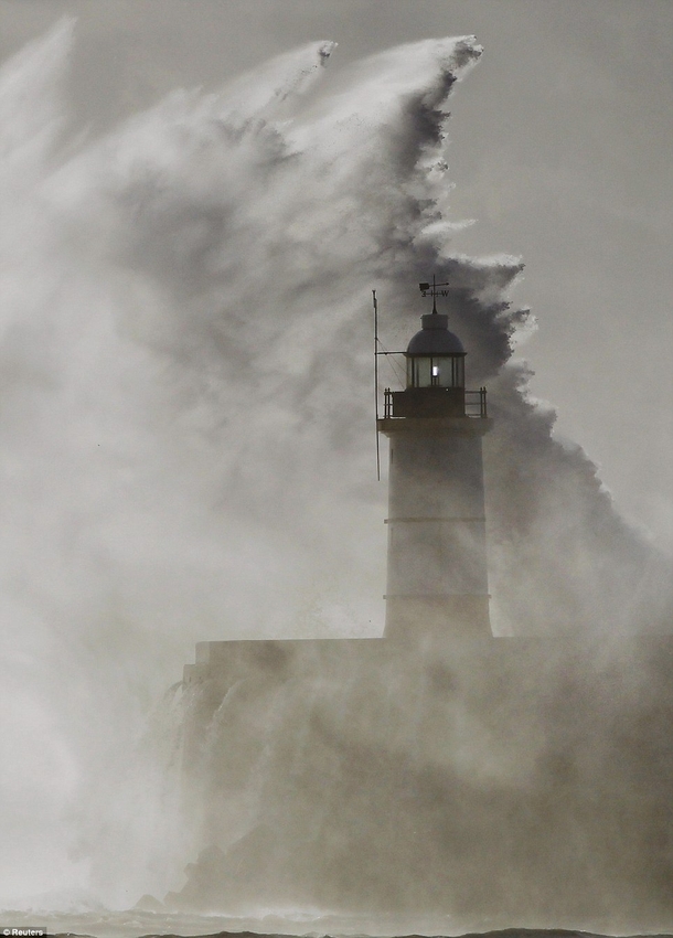 Big wave and lighthouse Newhaven England 
