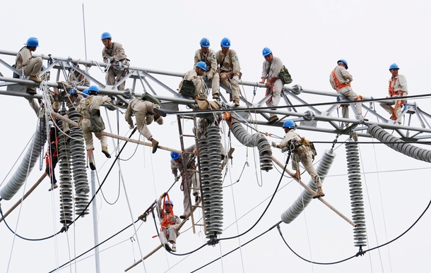 Birds on a wire eighteen workers repair an electric transformation substation in Xuzhou China August   