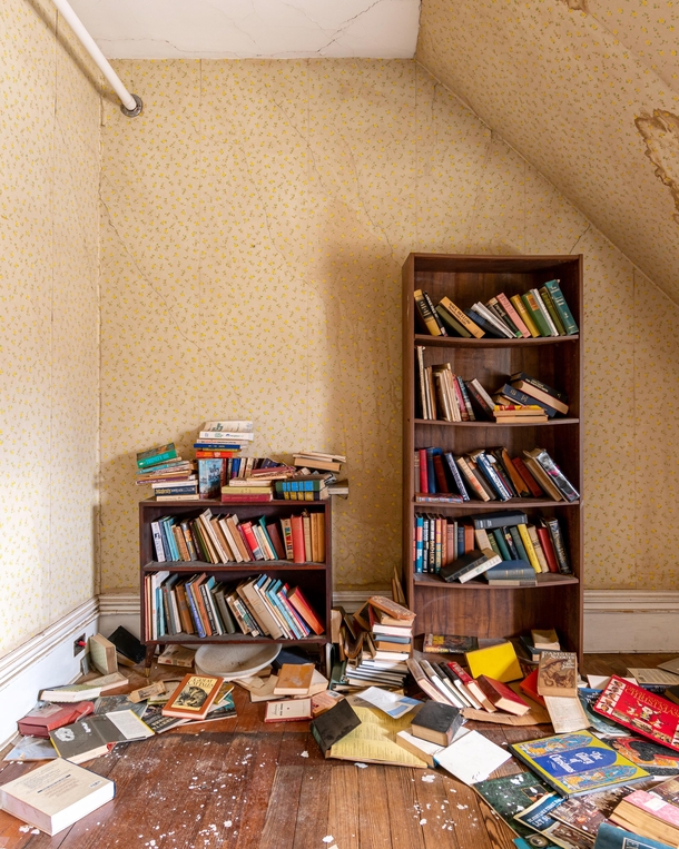 Books forgotten on their shelves in this abandoned nursing home