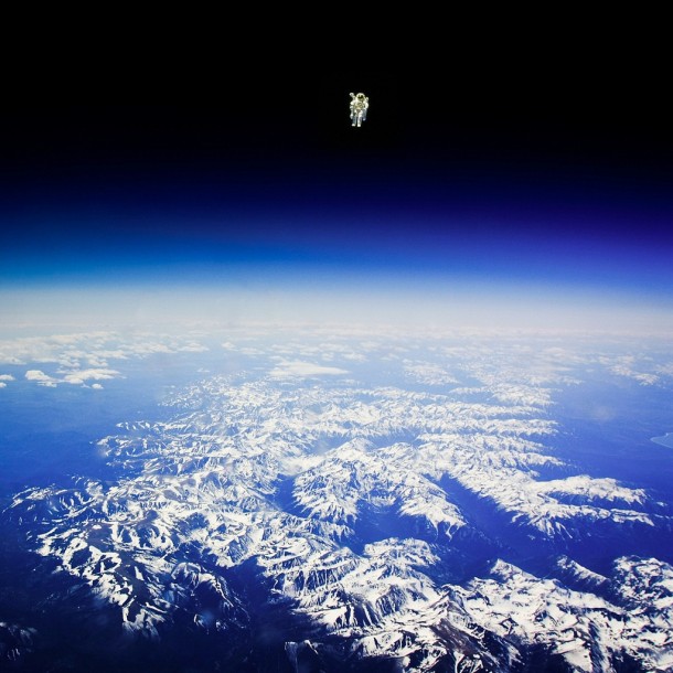 Bruce McCandless on the first untethered space walk in  Can anyone confirm if this is real or not In the more famous version there are no mountains visible but he appears to be in the exact same position here 