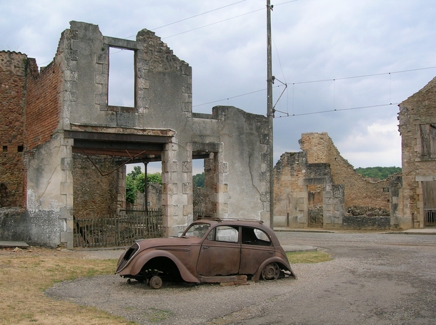 Burned out cars and buildings litter the remains of Oradour-sur-Glane after the village was massacred by the SS 