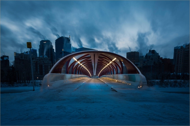 Calgarys Peace Bridge under leaden dawn skies 