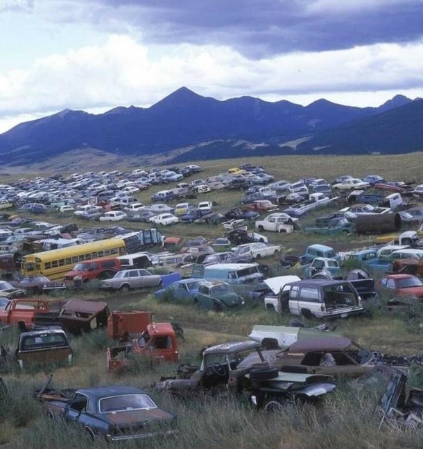 Car graveyard in the the shadows of the Rocky Mountains Montana