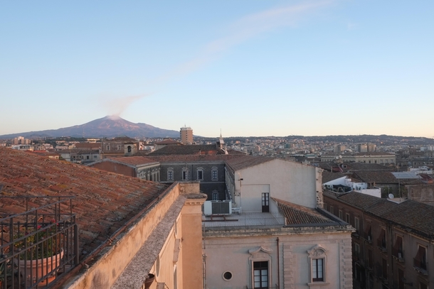 Catania Sicily Italy at Daybreak with Mt Etna smoking in the distance 