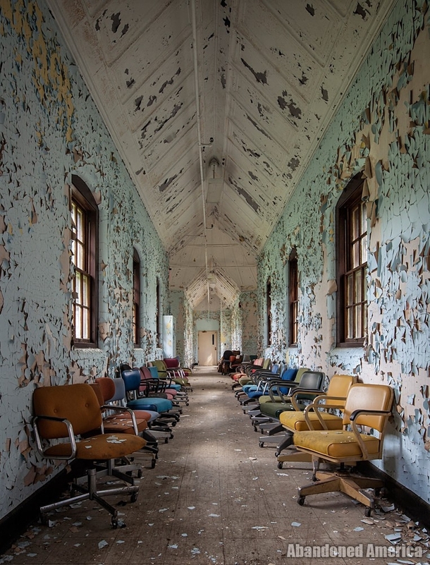 Chairs in a hallway in an abandoned asylum 