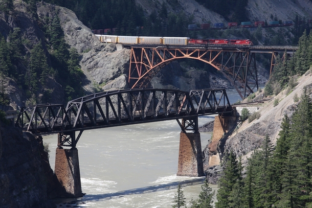 Cisco Bridges spanning the Fraser River at Siska British Columbia Canadian Pacific Railroad bridge in foreground amp Canadian National Railroad bridge in background with CPR train on it 
