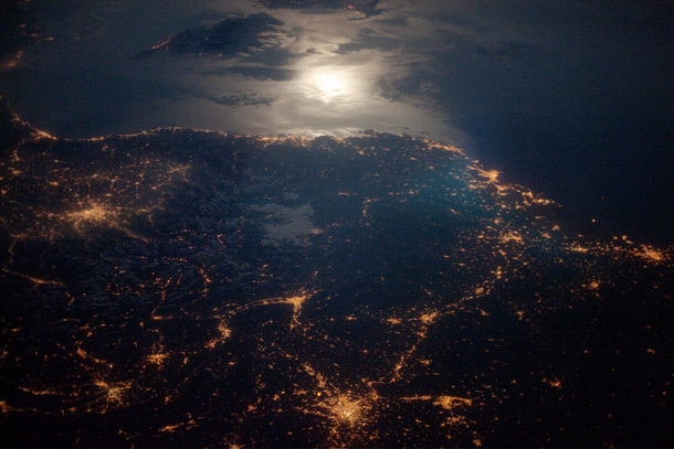 City Lights at Night along the France-Italy Border Moonglint and the lights of Torino Lyon and Marseille glitter in this nighttime astronaut photo of the Italy-France border region Earth photographed on  April  from the International Space Station Photo c