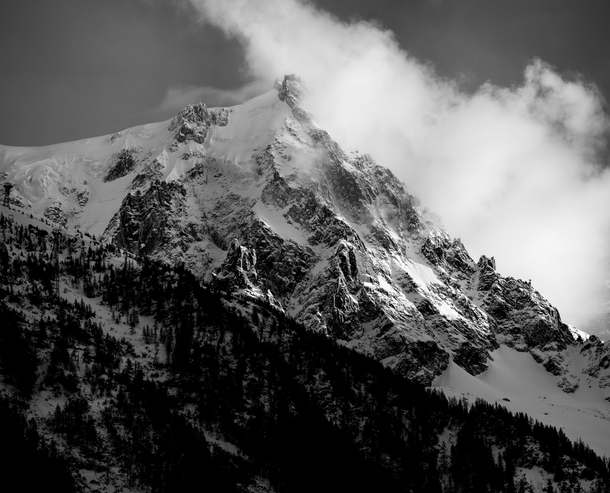 Clouds poking around the Aiguille du Midi in Chamonix France yesterday evening Zoom in to find the building 