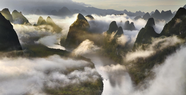 Cloudscape among the Yangshuo mountains of China  photo by Thierry Bornier
