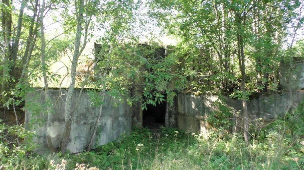 Concrete entrance to an earthen mound There was a bomb shelter
