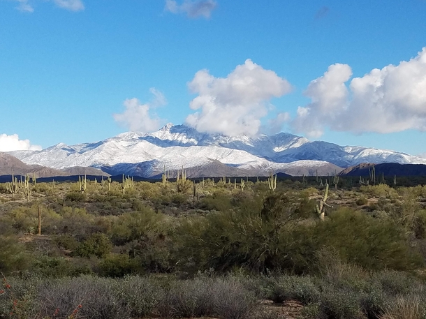 Contrasting snow capped Superstition Mountains and the desert landscape of Arizona 
