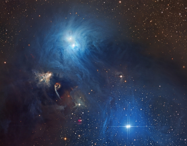 Cosmic dust clouds and young energetic stars around the constellation Corona Australis 