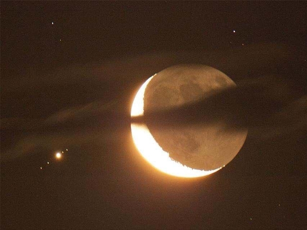 Crescent moon and Jupiter with four of its moons