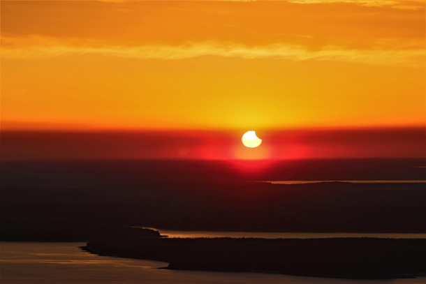 Crescent sunrise solar eclipse taken from Cadillac Mountain - Acadia National Park Maine USA -- 
