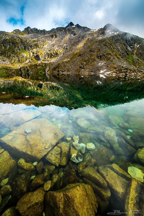 Crystal clear alpine waters of Gold Cord Lake in Alaska USA