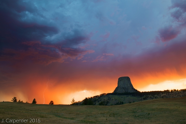 Devils Tower sunset storm with a lightning strike 