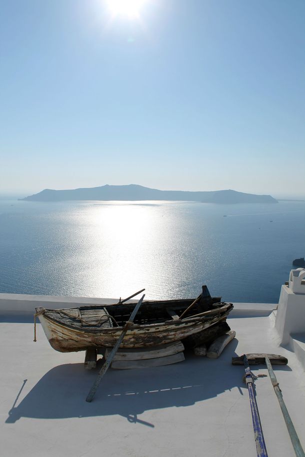Distant Volcano with an abandoned rowing boat Santorini Greece 