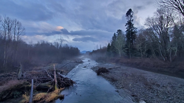 Dungeness River with the Olympic Mountains far in the distance on a rainy winter day - Sequim WA 