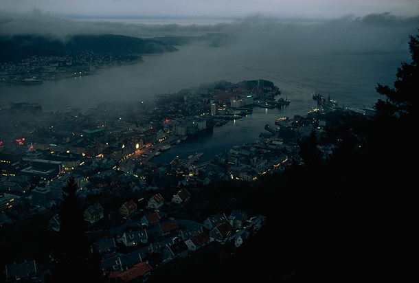 Embracing the fjord a dusk-dimmed Bergen laps against mountain walls Norway  x