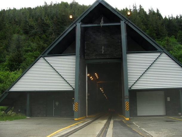 Entrance to Alaskas Whittier Tunnel a unique km tunnel that uses scheduling to share a single lane between both road vehicles and trains 