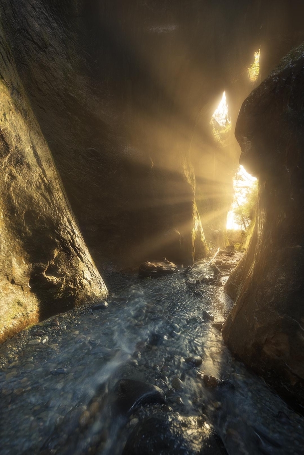 Every winter there is a period where the setting sun lines up with this little slot canyon creating beautiful rays from the waterfall within Gotta love the southwest coast of Vancouver Island  tristantodd