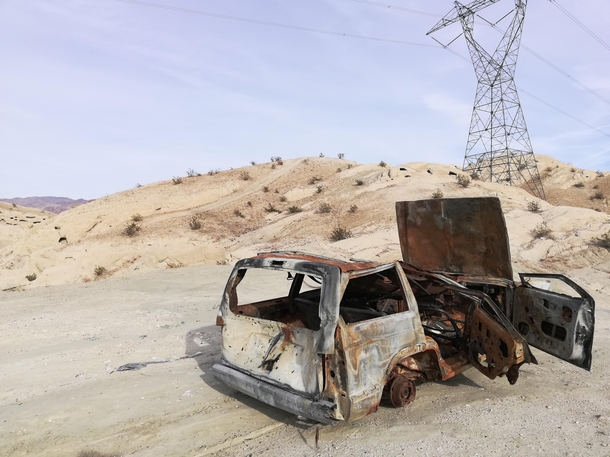 Final resting grounds of an old Jeep rusting out in the dry desert of Indio California