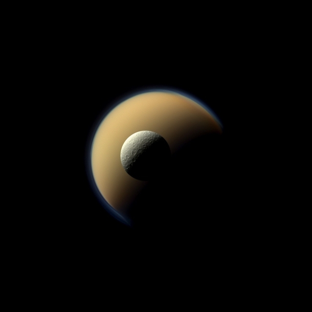 Fire and Ice Saturns largest and second largest moons Titan and Rhea juxtaposed in this true-colour image taken by the Cassini spacecraft 