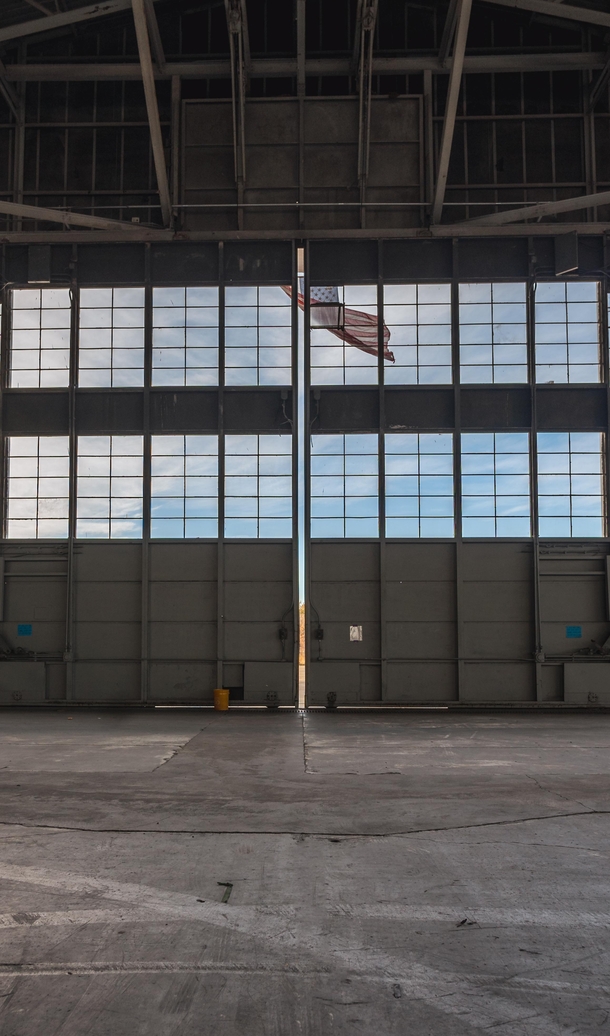 Flag hanging from an abandoned naval airbase hangar