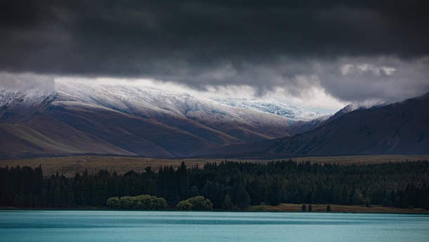 For just a few fleeting moments the mountains almost seemed to be sandwiched between the clouds and the brilliant turquoise waters of Lake Tekapo The light and shadow play that morning was just magical South Island New Zealand  OC IG arvindj
