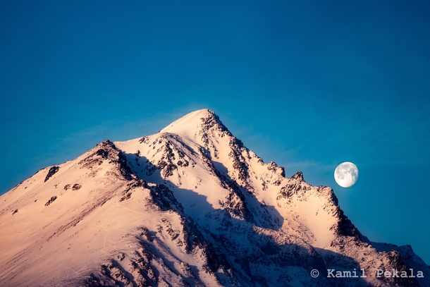Full moon setting over Tatra mountains in Slovakia 