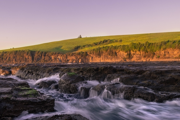 Golden Hour Hill Gerringong NSW Australia Where the ocean meets the mountains is a very special place The beautiful rolling greens hills surround the ocean here and Ive always tried to capture it just like this image Very stoked  IG  jyeberryphoto