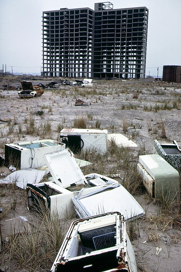 Greetings from New York  style Skeleton of apartment building never completed abandoned refrigerators and a burned out  Ford Mustang Breezy Point Queens looking toward Brooklyn New York Photo by Andy Blair 