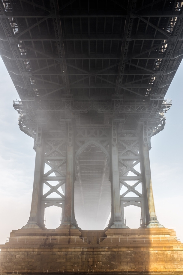 Heavy fog rolled into NYC this morning making for this awesome scene underneath the Manhattan Bridge 