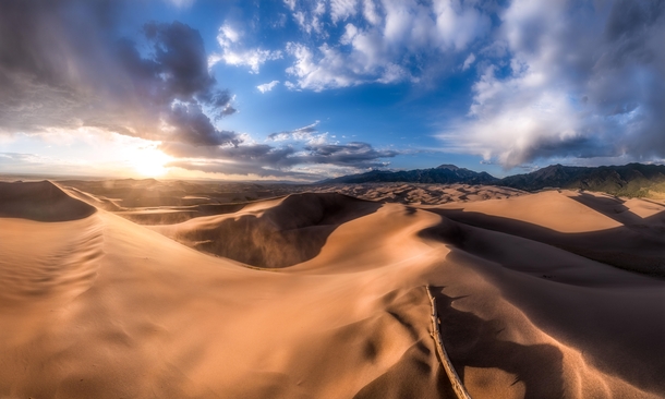 High Dune Sunset Awe-inspiring sunset at Great Sand Dunes NP in Colorado This place is truly one of a kind The tallest dunes in North America sit right next to the rugged Sangre de Cristo mountain range The natural contrast of the landscape is incredible 
