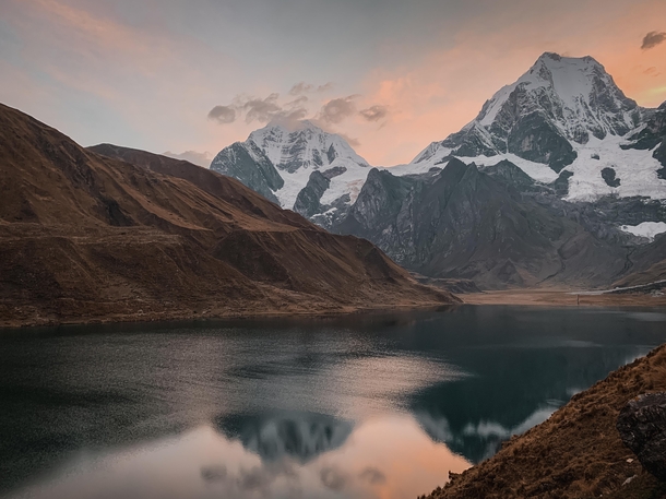 Hiked for  hours in rainy miserable conditions before setting up camp along this lake The skies cleared up just in time for sunset and we had this incredible view from our campsite Cordillera Huayhuash Peru 