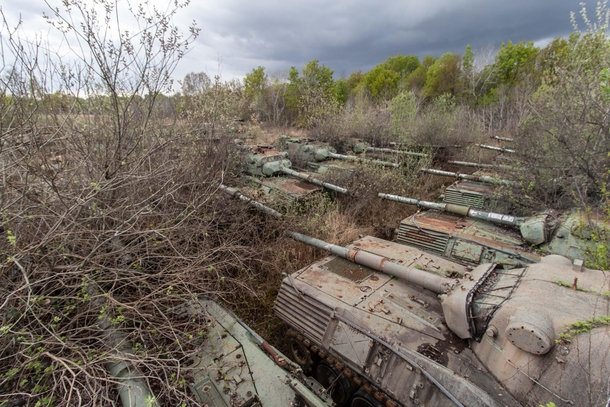 Hundreds of old tanks rotting in a field 