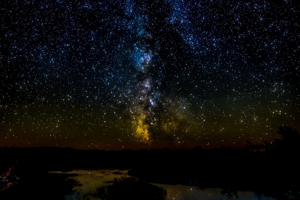 I captured this shot of the Milky Way reflected in a lake in Northern Maine OC