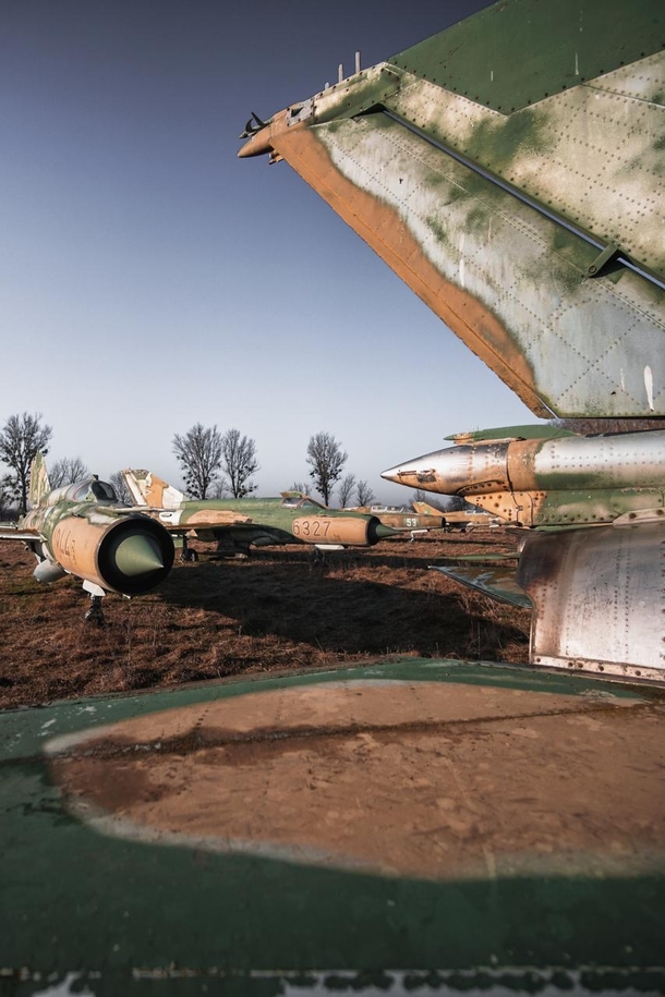 I found dozens of abandoned MiG- Jet Planes parked on a field 